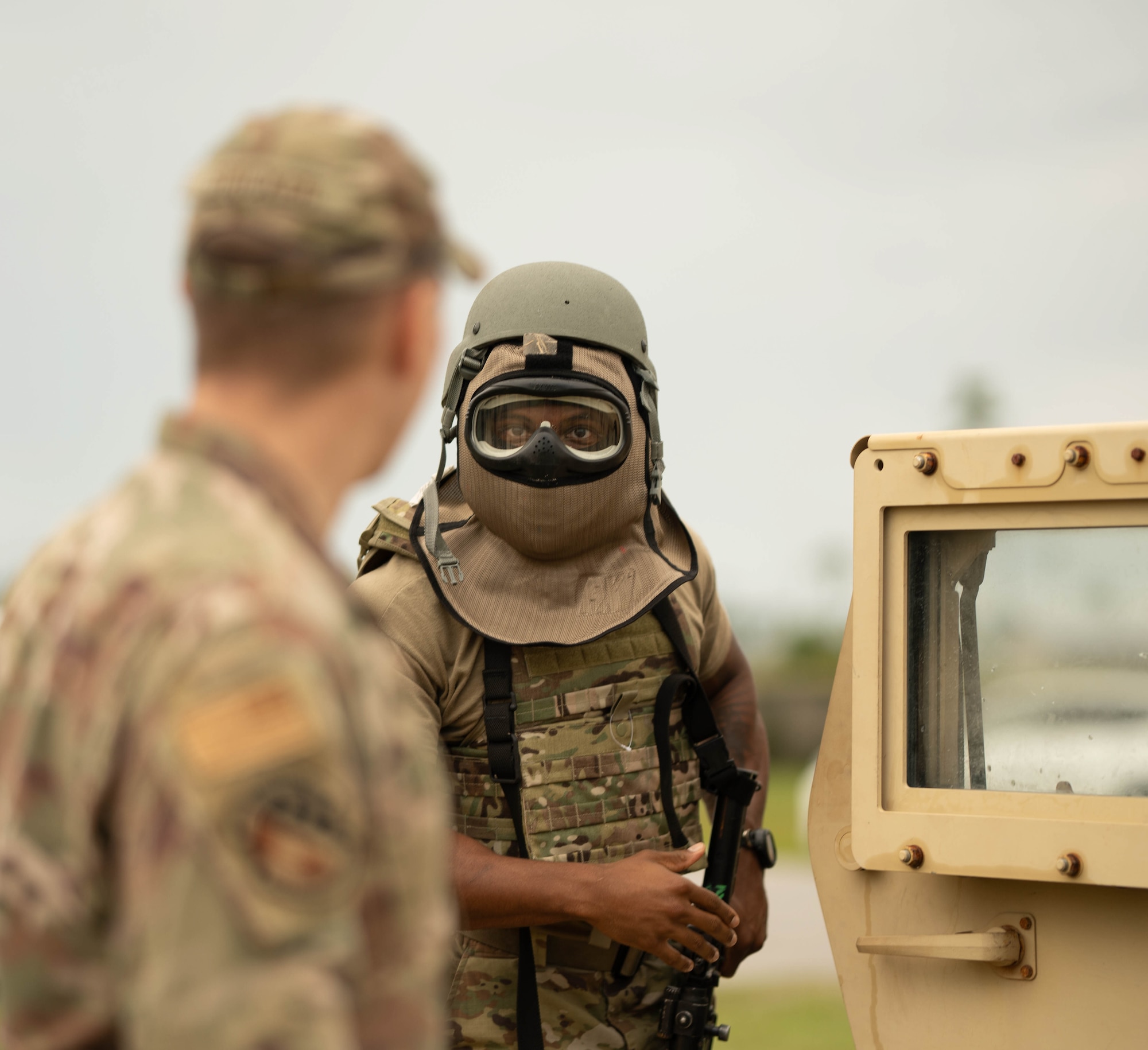 U.S. Air Force Senior Airman Dante Ellis, 325th Communications Squadron cyber systems operations technician, speaks with U.S. Air Force Staff Sgt. Daniel Stricker, 325th CS unit deployment manager, during exercise Ground-to-Air Transmit and Receive Aid.
