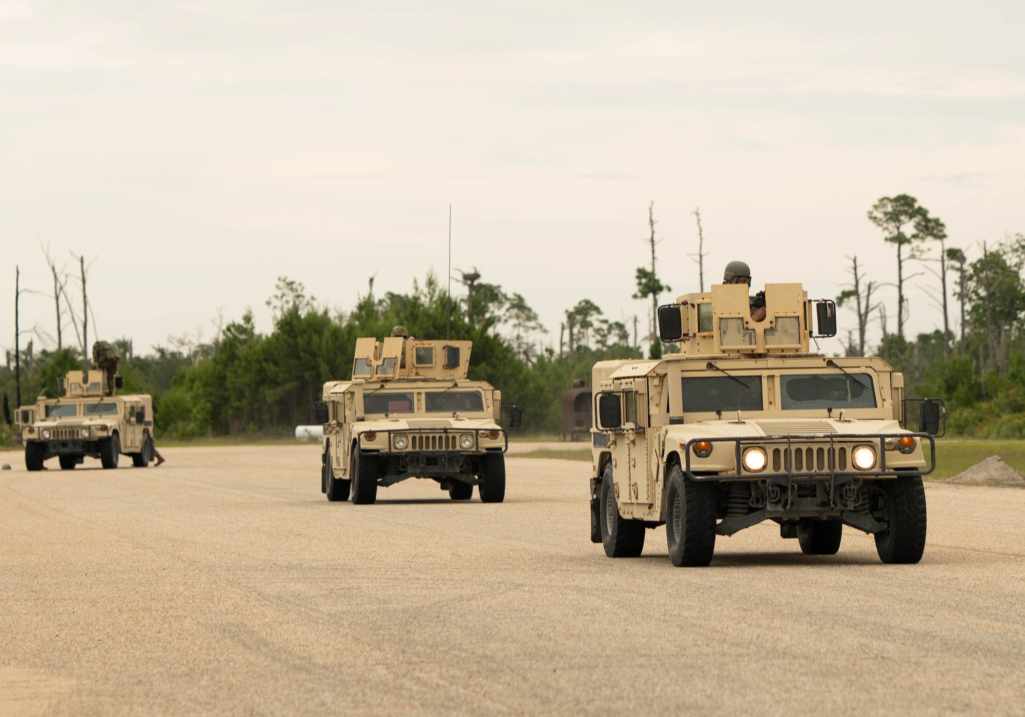 U.S. Airmen assigned to the 325th Communications Squadron drive a convoy of Humvees during exercise Ground-to-Air Transmit and Receive Aid.