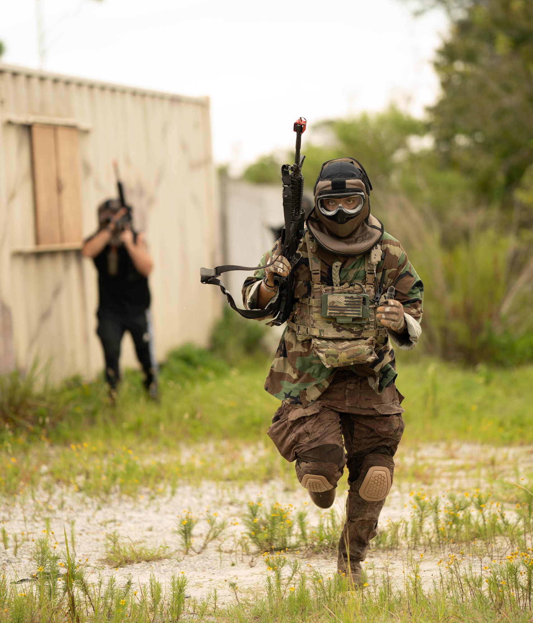 U.S. Air Force Senior Airman Christopher Barron, 325th Security Forces Squadron noncommissioned officer in charge of electronic security systems, simulates tactical opposition in a mock village during exercise Ground-to-Air Transmit and Receive Aid.