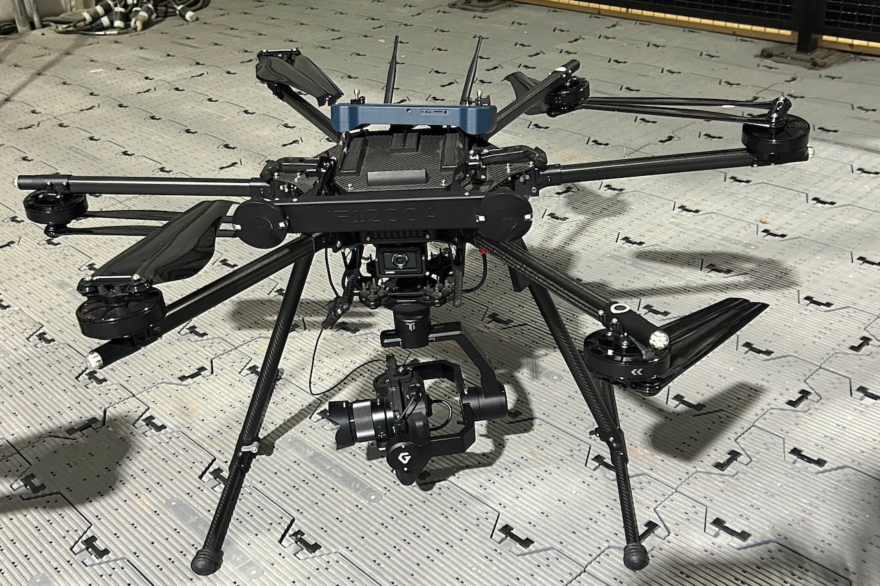 A quadcopter drone sits on the ground.