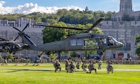 A New York Army National Guard UH-60M Black Hawk helicopter hovers above The Plain at the United States Military Academy at West Point on August 28, 2025 as Soldiers from the 101st Airborne Division (Air Assault) fast rope down to the ground during a capabilities demonstration for cadets.