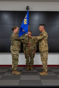 Lt. Col. Christopher Escajeda presents the guidon to Lt. Col. Venus Victorino