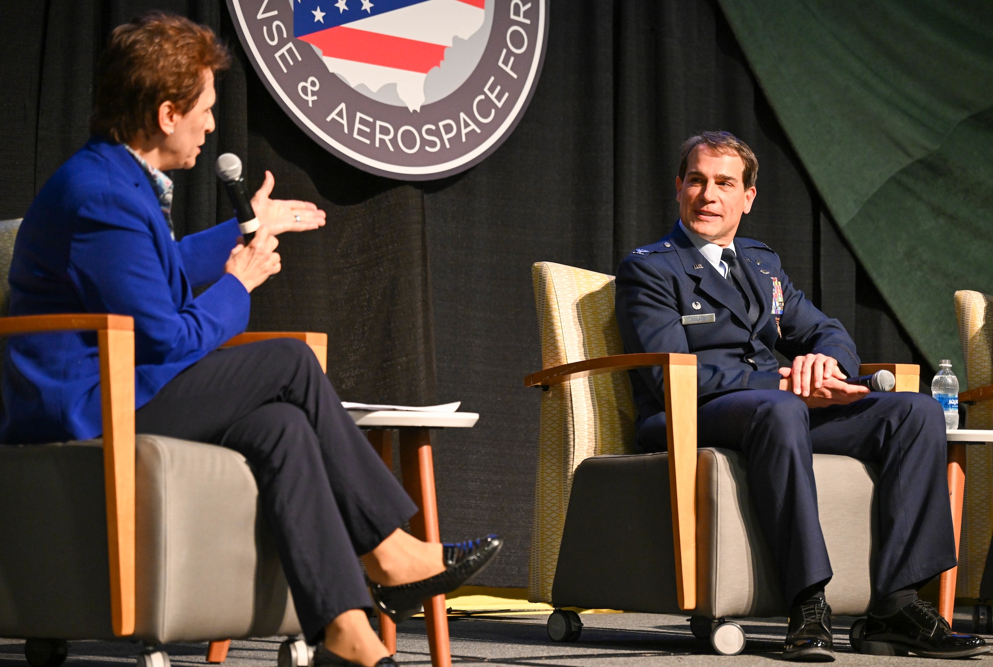 Col. Chris Sedlacek, 910th Airlift Wing commander, listens as moderator retired Col. Cassie Barlow, Strategic Ohio Council for Higher Education president, asks a question during "Installations Panel: Non-traditional threats – The role in modern society in war and peace" at Wright State University, Dayton, Ohio, Sept. 15, 2025.