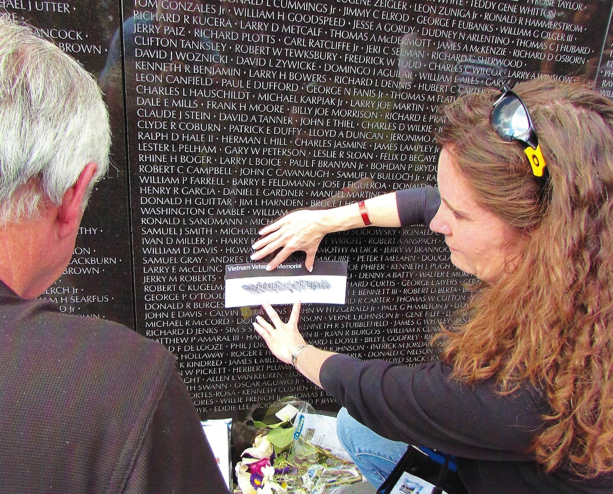 Al Bailey, left, Honor Flight Dayton president, and Kelley Cox, right, Honor Flight Dayton board member, conduct a rubbing of Steve Moseley during the Honor Flight Dayton’s Honoring Yesterday’s Heroes Program at the Vietnam Wall in Washington, D.C., 2014. Bailey and Moseley were friends in the service who trained, went to Vietnam and were set to redeploy together. Unfortunately, Moseley was killed in action Dec. 12, 1967, two weeks before he was scheduled to return home. (Courtesy photo from Bailey)