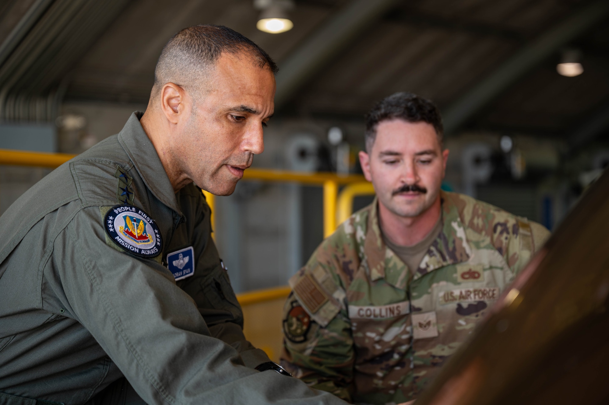 U.S. Air Force Gen. Adrian Spain, Air Combat Command commander, left, and Staff Sgt. Gregory Collins, 325th Maintenance Squadron fleet health manager, observe the canopy reduction process on an F-35A Lightning II