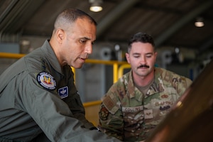 U.S. Air Force Gen. Adrian Spain, Air Combat Command commander, left, and Staff Sgt. Gregory Collins, 325th Maintenance Squadron fleet health manager, observe the canopy reduction process on an F-35A Lightning II