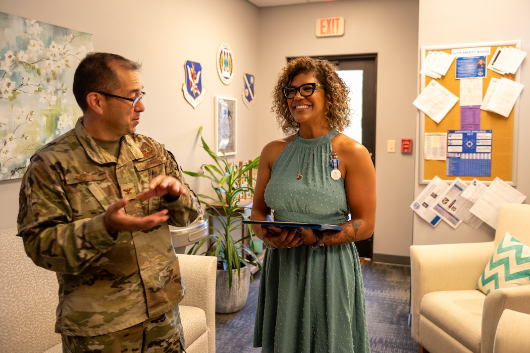 Two people talk after one receives an award.