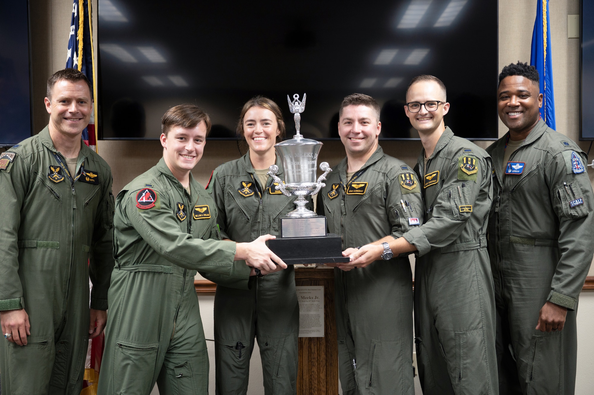 Lt. Col. James Bresnahan, 11th Bomb Squadron commander, and Lt. Col. Millard Matthews, III, 93rd Bomb Squadron commander, pose with an FTU aircrew