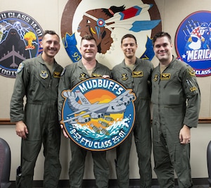 Recent graduates of the B-52 Formal Training Unit pose for photos