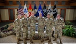 U.S. Air National Guard Master Sgt. David Torres, Tech. Sgt. Michael Barkman, Senior Master Sgt. Vitaliy Gorbachyk, Staff Sgt. Eduardo Rosado, Staff Sgt. Richard Pyrdol and Capt. Jeffrey McDonald, all members of the 103rd Airlift Wing’s Force Support Squadron, stand together while serving the Air Force Mortuary Affairs Operations mission Sept. 15, 2025. The group fills various roles within AFMAO to ensure respect and dignity for the nation’s fallen.