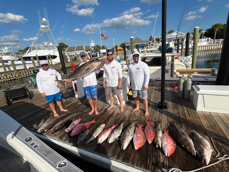 Picture of a group with fish they caught.