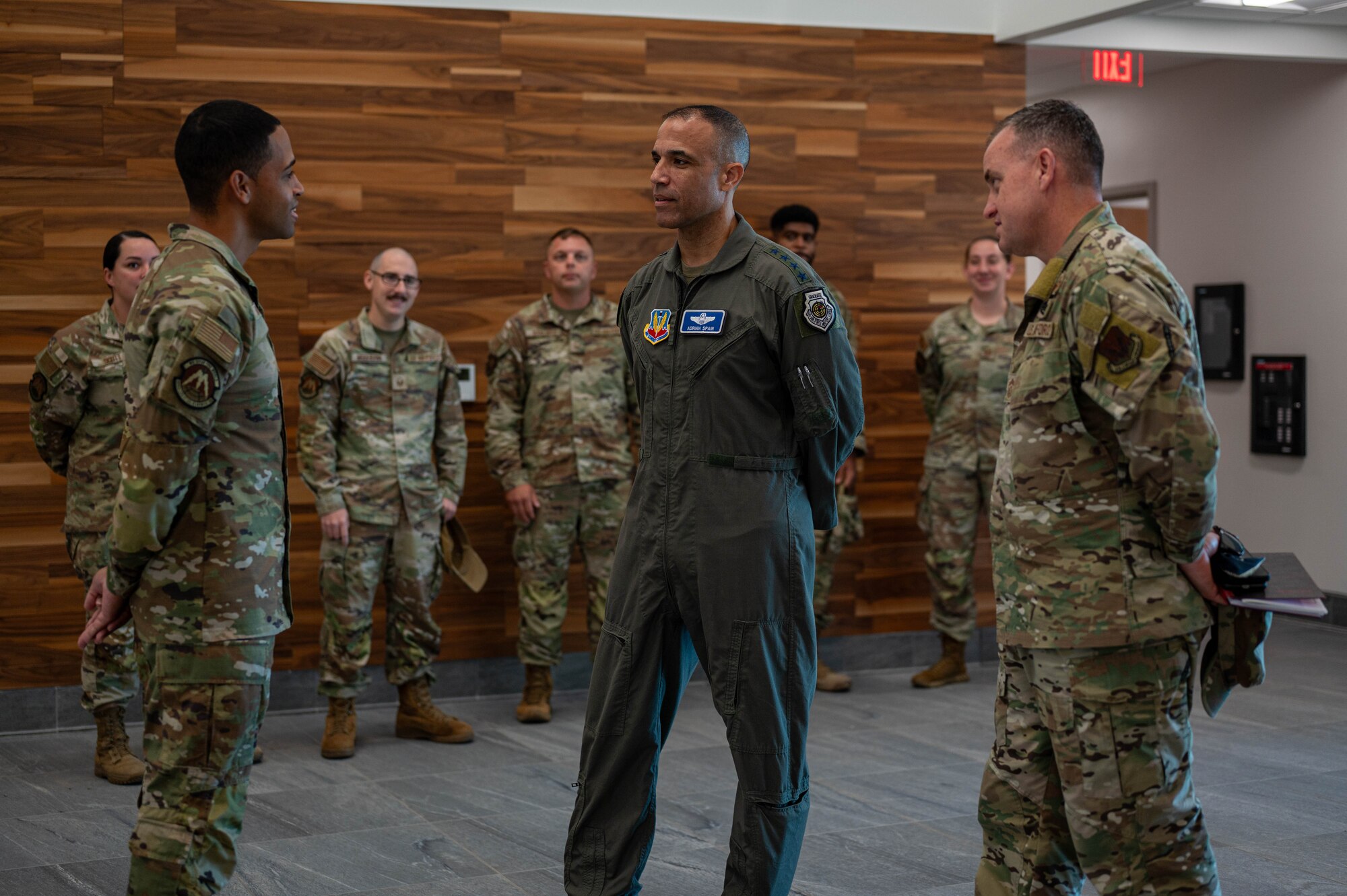 Gen. Adrian Spain, Air Combat Command commander, center, and Chief Master Sgt. Jeremy Unterseher, ACC command chief,  right, meet Master Sgt. Brandon Vazquez