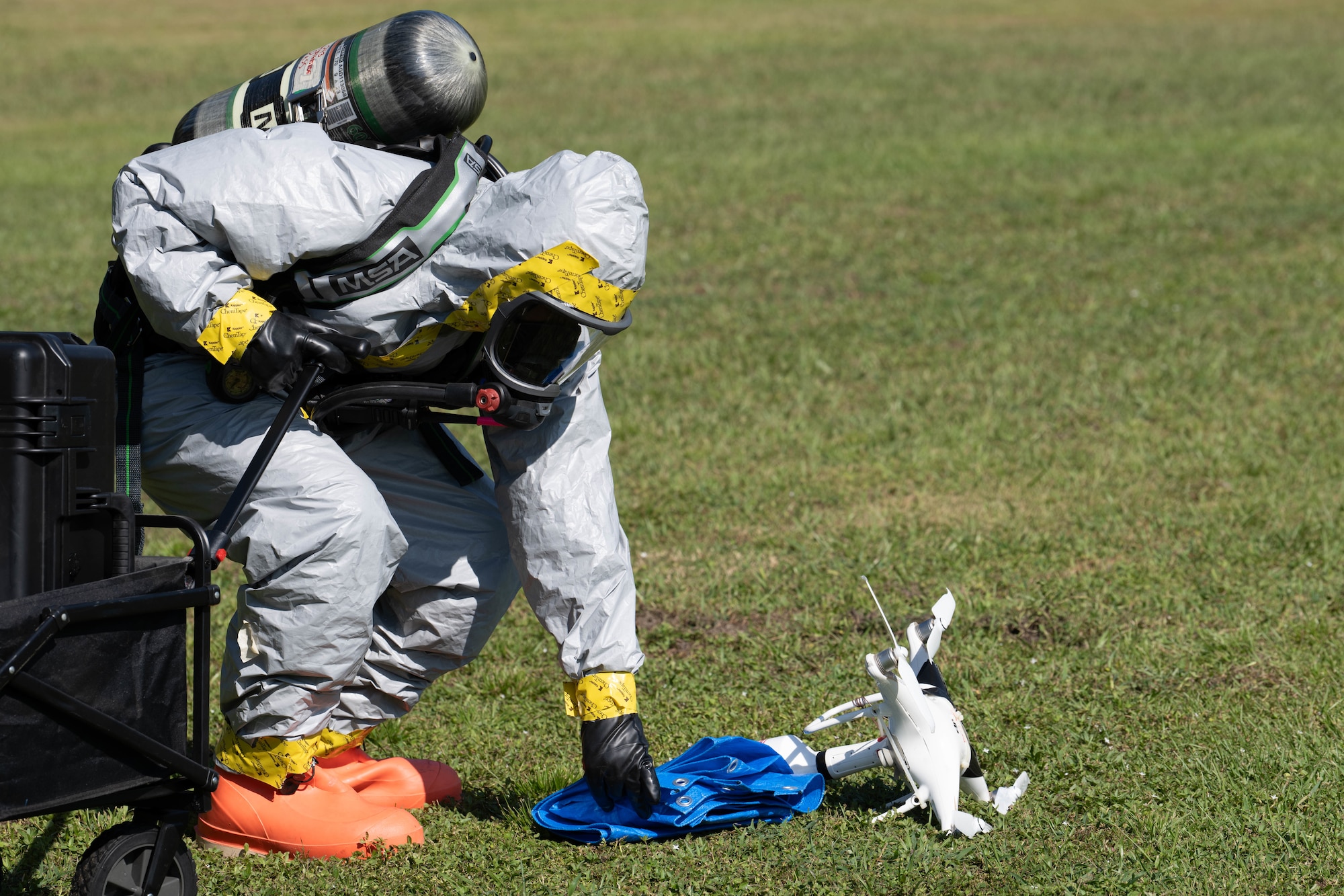 A Chemical, Biological, Radiological and Nuclear team member assigned to the 1st Special Operations Wing inspects a downed drone during Exercise Commando Response at Hurlburt Field, Florida, Sept. 8, 2025.