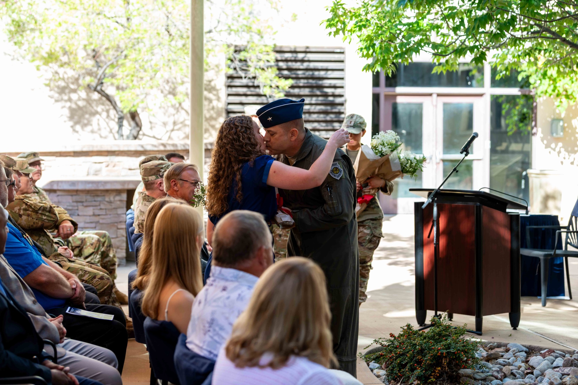 Brig. Gen. Jesse Friedel presents flowers and thanks his wife Jennifer and daughters Josyln and Jacquelyn for their support during the Air Force Operational Test and Evaluation Center Change of Command held Sept. 16, 2025.