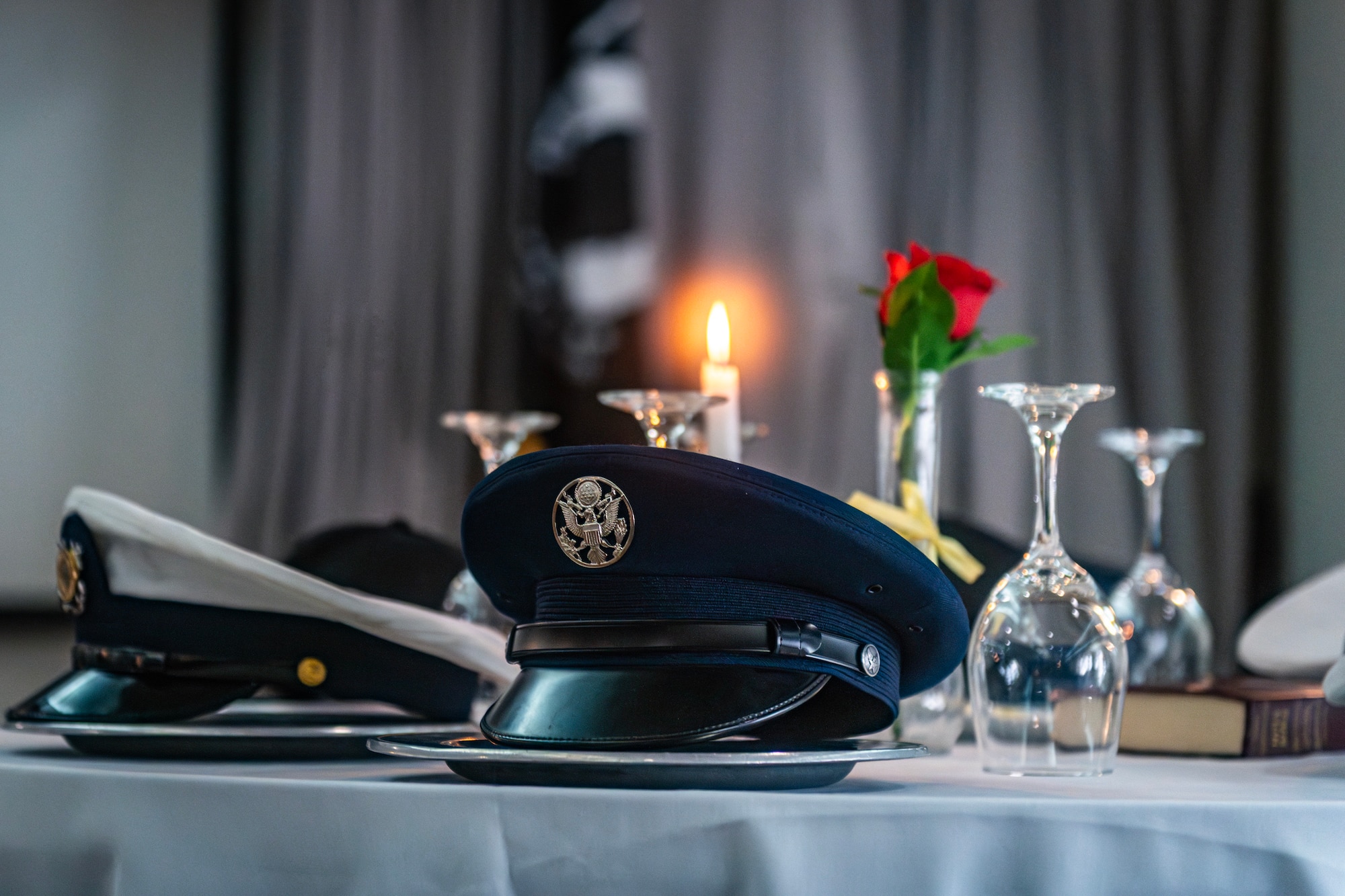 A candle stays lit at the POW/MIA table during a luncheon event on Edwards Air Force Base, California, Sept. 12. The luncheon was held in honor of POW/MIA Recognition Day, Sept. 19. The candle symbolizes a guiding light for servicemembers to find their way home and as the enduring hope of their families. (Air Force photo by Giancarlo Casem)
