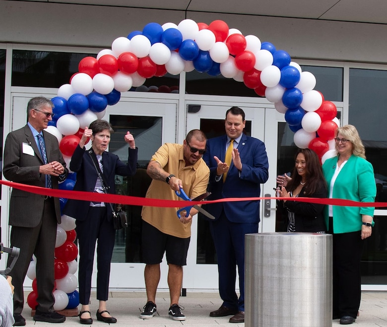 Marine Veteran Christopher Scott Louie, center, cuts the ribbon during a ceremony celebrating the opening of the VA Long Beach Healthcare System's mental health in-patient and out-patient facilities Aug. 28 in Long Beach, California. Also pictured are, from left to right, Dr. Larry Albers, chief of psychiatry and mental health; Dr. Carolyn Clancy, Assistant Under Secretary for Health for Discovery, Education and Affiliate Networks; Walt Dannenberg, VA Long Beach Medical Center director; Dr. Sharon De Peralta, chief of Patient Care Services, Mental Health; and Stephanie Young, VISN Interim Network director.