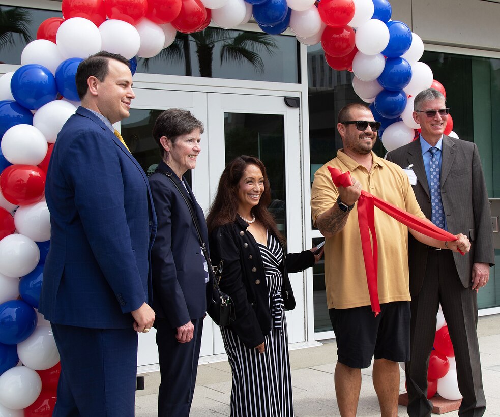 VA officials pose for a picture following a ribbon-cutting ceremony signifying the opening of two mental health facilities at the VA Long Beach Healthcare System Aug. 28 in Long Beach, California. Pictured, from left to right, are Walt Dannenberg, VA Long Beach Medical Center director; Dr. Carolyn Clancy, Assistant Under Secretary for Health for Discovery, Education and Affiliate Networks; Dr. Sharon De Peralta, chief of Patient Care Services, Mental Health; Marine Veteran Christopher Scott Louie, who cut the ribbon during the ceremony; and Dr. Larry Albers, chief of psychiatry and mental health.
