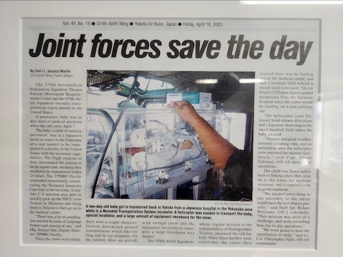 A newspaper shows an infant resting in an incubator
