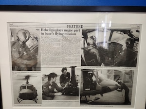 A newspaper clipping highlights the UH-1N Huey