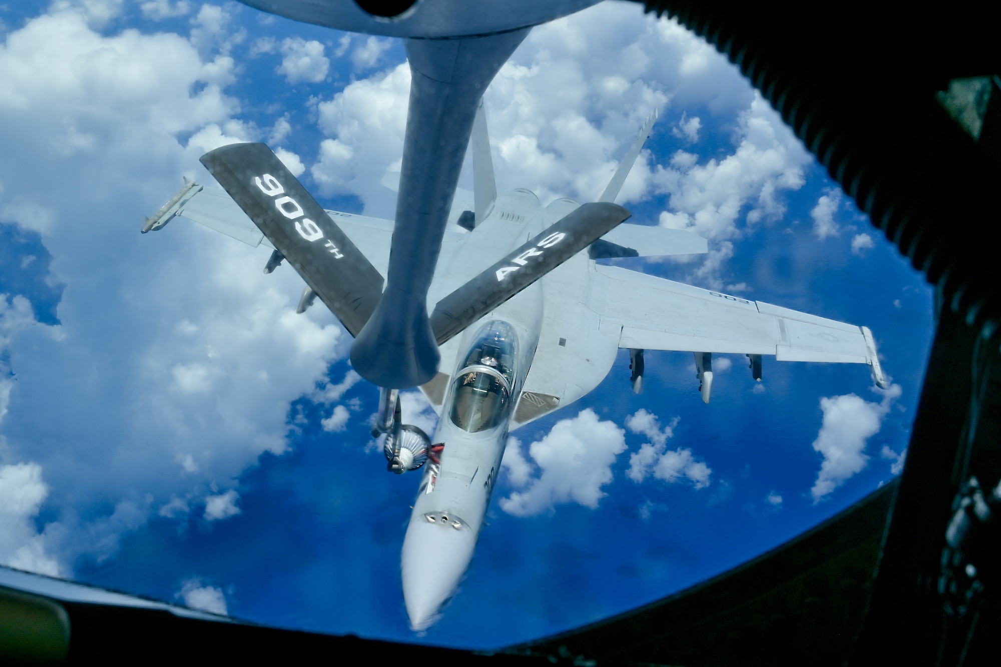 A KC-135 Stratotanker refuels a U.S. Navy aircraft.