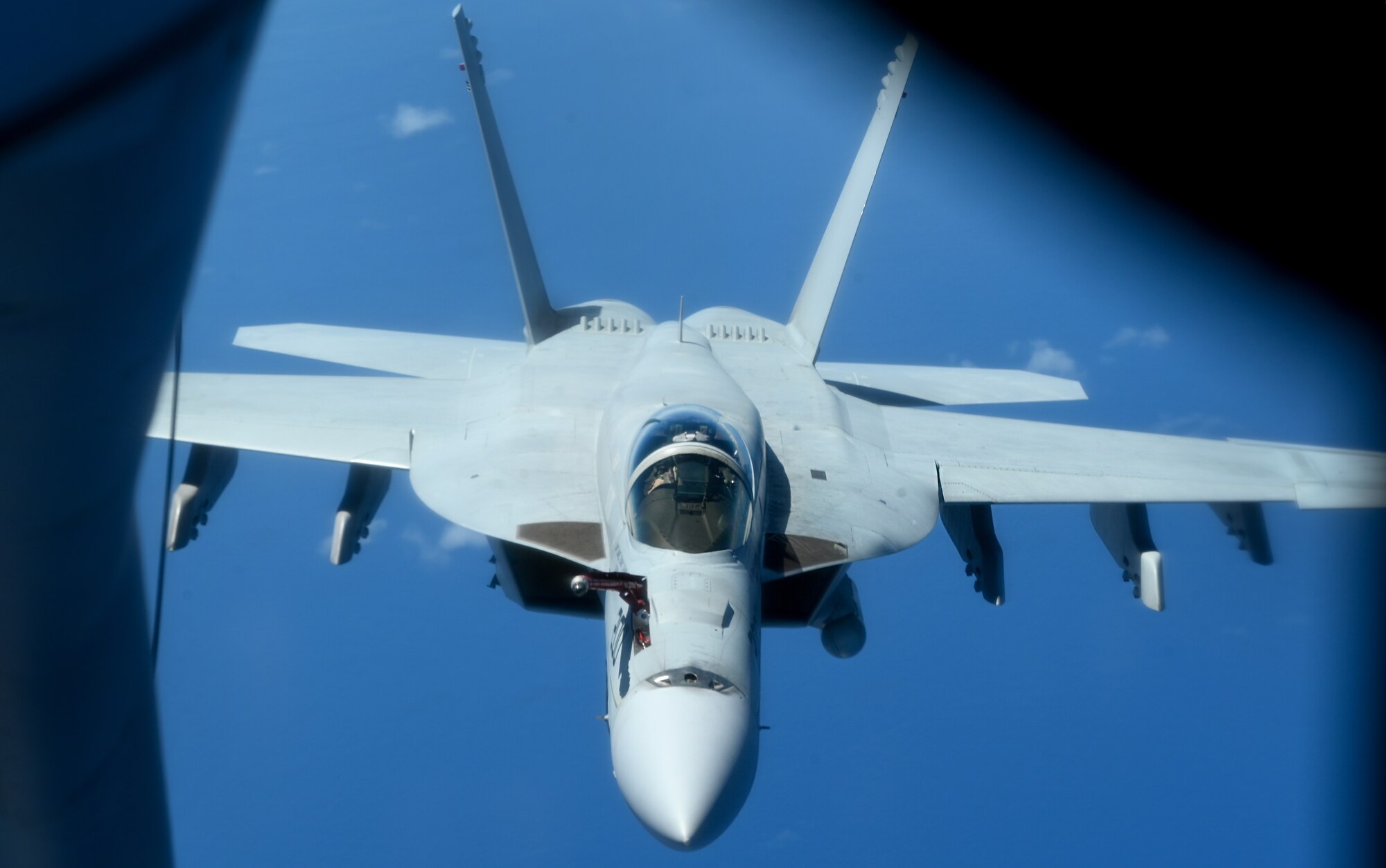 A U.S. Navy aircraft approaches a KC-135 Stratotanker.