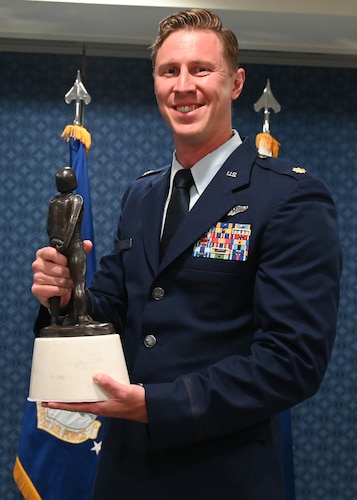 Maj. Green hold his awards.
