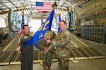 Col. Michael Medrano, 433rd Operations Group interim commander, presents the 433rd Contingency Response Squadron guidon to Major Alexander Williams, 433rd CRS commander, during a redesignation ceremony at Joint Base San Antonio-Lackland, Texas, Sept. 6, 2025. The redesignation, effective Sept. 1, elevates the 433rd Contingency Response unit from flight to squadron status, formally recognizing years of growth, transformation, and operational success. (U.S. Air Force photo by Master Sgt. Jacob Lewis)