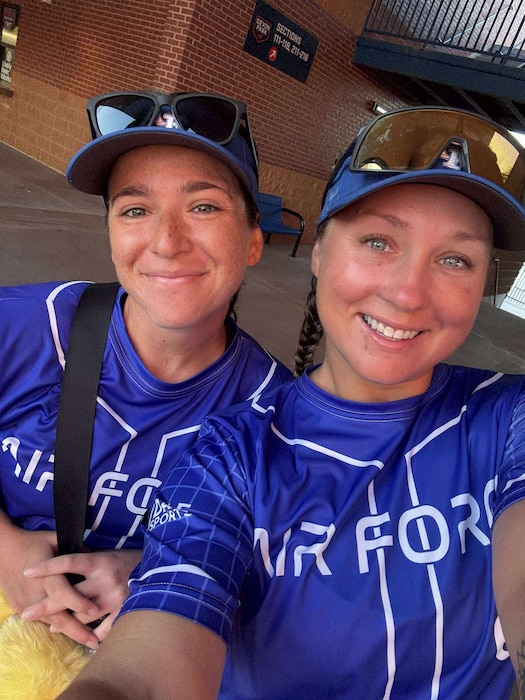 Two women wearing Air Force softball uniforms posing for a selfie