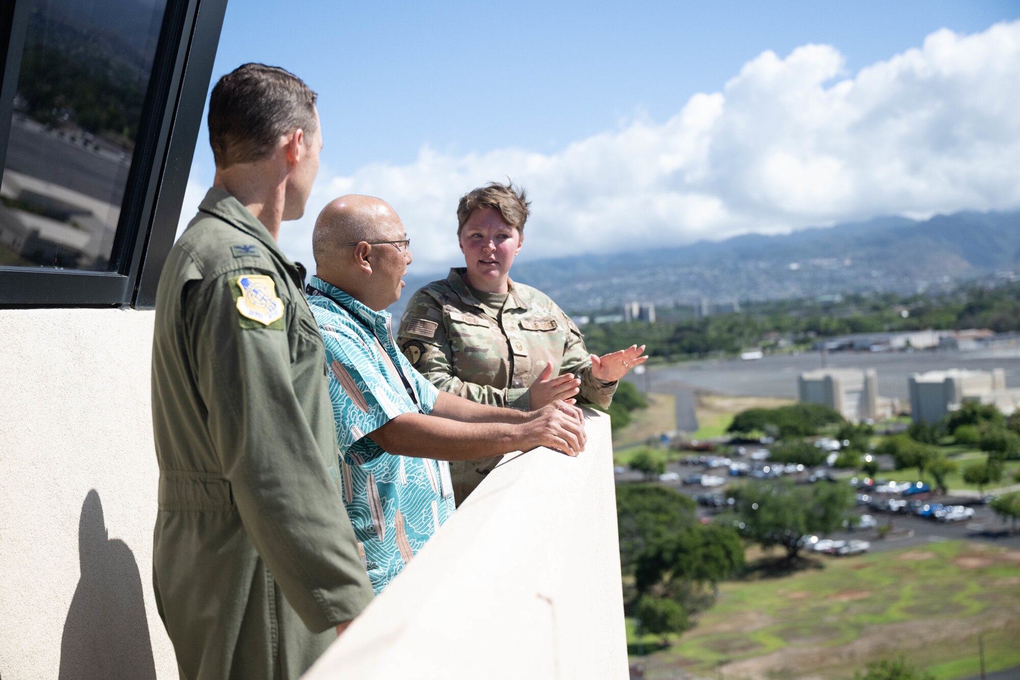 U.S. Air Force Airmen show a civilian the ramp from a air traffic control tower on Joint Base Pearl Harbor-Hickam, Hawaii.