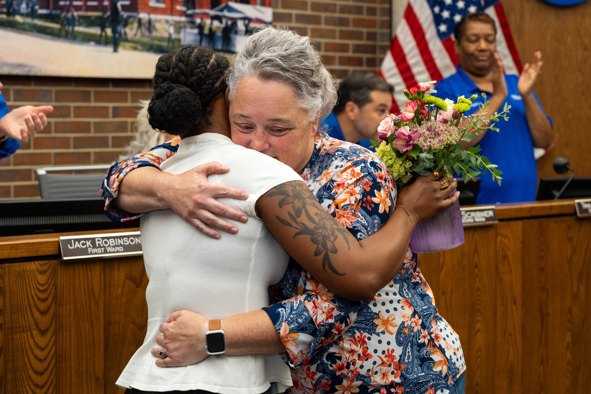 Melissa Johnson, right, hugs U.S. Air Force Senior Airman Jada McMillan, 509th Operational Medical Readiness Squadron medical technician, during a city council meeting in Sedalia, Missouri, Sept. 2, 2025.