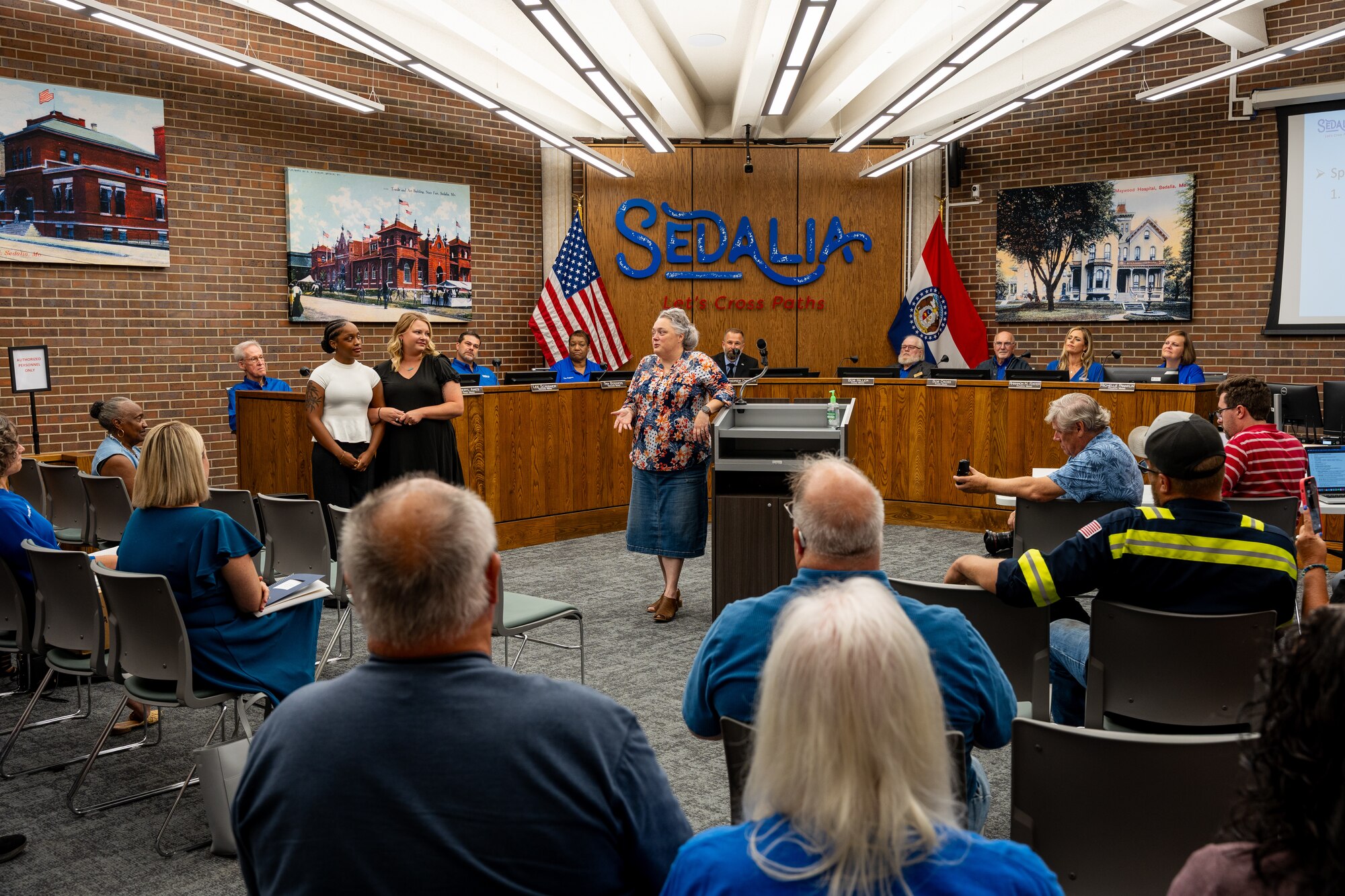 Melissa Johnson, center, gives a testimony in front of community members during a city council meeting in Sedalia, Missouri, Sept. 2, 2025.