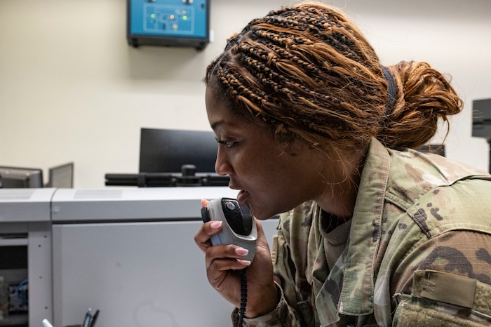 U.S. Air Force Senior Airman Lauren Waits, 51st Fighter Wing senior emergency actions controller, uses the giant voice system at Osan Air Base, Republic of Korea, Sept. 10, 2025. Waits earned the title of Mustang of the Week for her exceptional contributions within her duties in the command post and for her dedication outside of the vault. (U.S. Air Force photo by Staff Sgt. Jason W. Cochran)