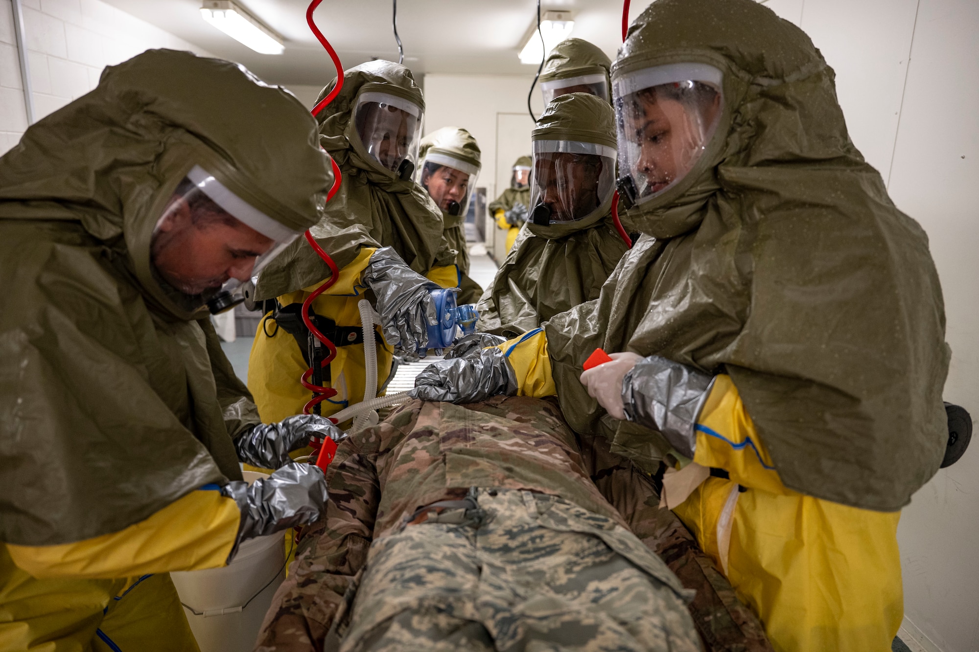 U.S. Air Force U.S. Air Force Airmen assigned to the 51st Medical Group cut away clothing from a training mannequin during a chemical attack response drill at Osan Air Base, Republic of Korea, Sept. 11, 2025.