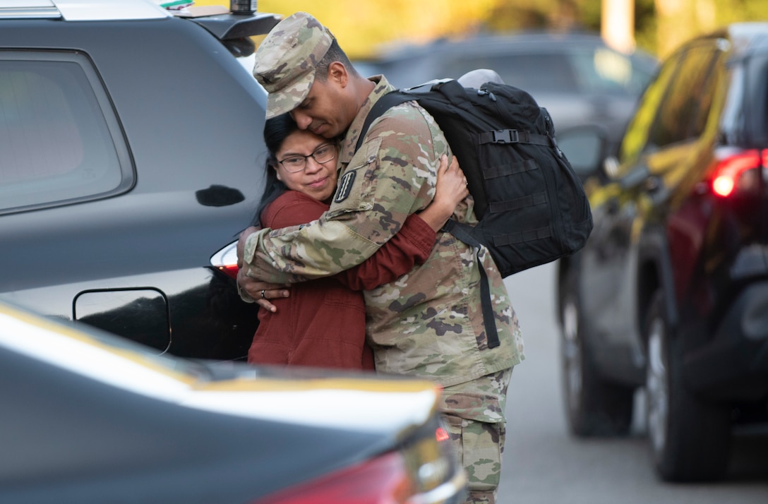 Soldier hugs family member ahead of departure