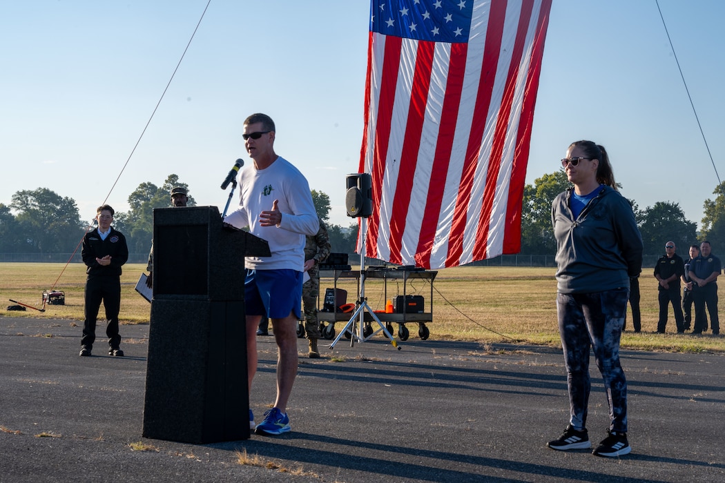 Col. Dustin Richards, commander of the 88th Air Base Wing and Installation, and Chief Master Sgt. Tessa Fontaine, command chief of the 88th Air Base Wing, deliver opening remarks at Wright-Patterson Air Force Base, Sept. 11, 2025. Several hundred members of the Wright-Patt community participated in the annual Run for the Fallen to honor those killed in the Sept. 11 terrorist attacks. (U.S. Air Force photo by Jack Gardner)