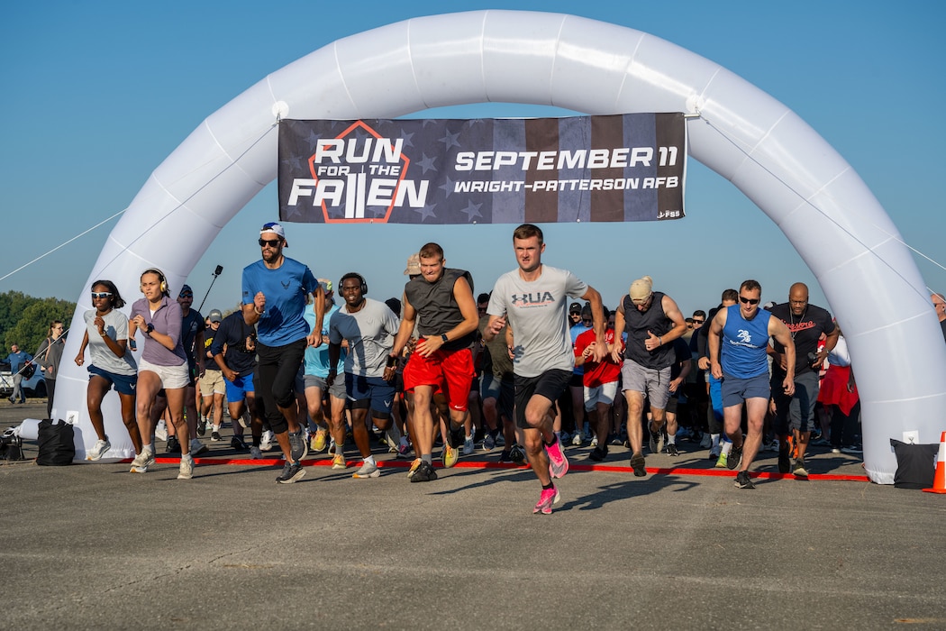 Participates for the Run for the Fallen take off from the start line at Wright-Patterson Air Force Base, Sept. 11, 2025. Several hundred of Wright-Patt community members came out to take part in the annual Run for the Fallen in remembrance of those killed in the Sept. 11 terrorist attacks. (U.S. Air Force photo by Jack Gardner)