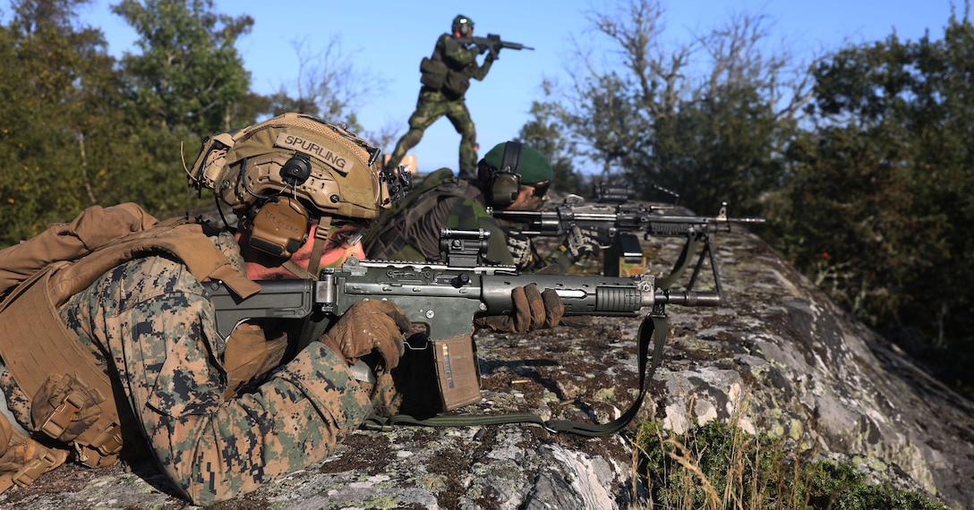 U.S. Marine Corps Cpl. Hayden Spurling, a LAV-25 gunner with Alpha Company, 2d Light Armored Reconnaissance Battalion, 2d Marine Division, engages U.S. and Swedish Marines acting as opposition forces alongside Swedish Marines during Exercise Archipelago Endeavor 2025 in Korso, Sweden, Sept. 7, 2025. The exercise strengthens the relationship between the United States and Sweden and provides a unique training opportunity for both countries. (U.S. Marine Corps photo by Cpl. Xavier Alicea)