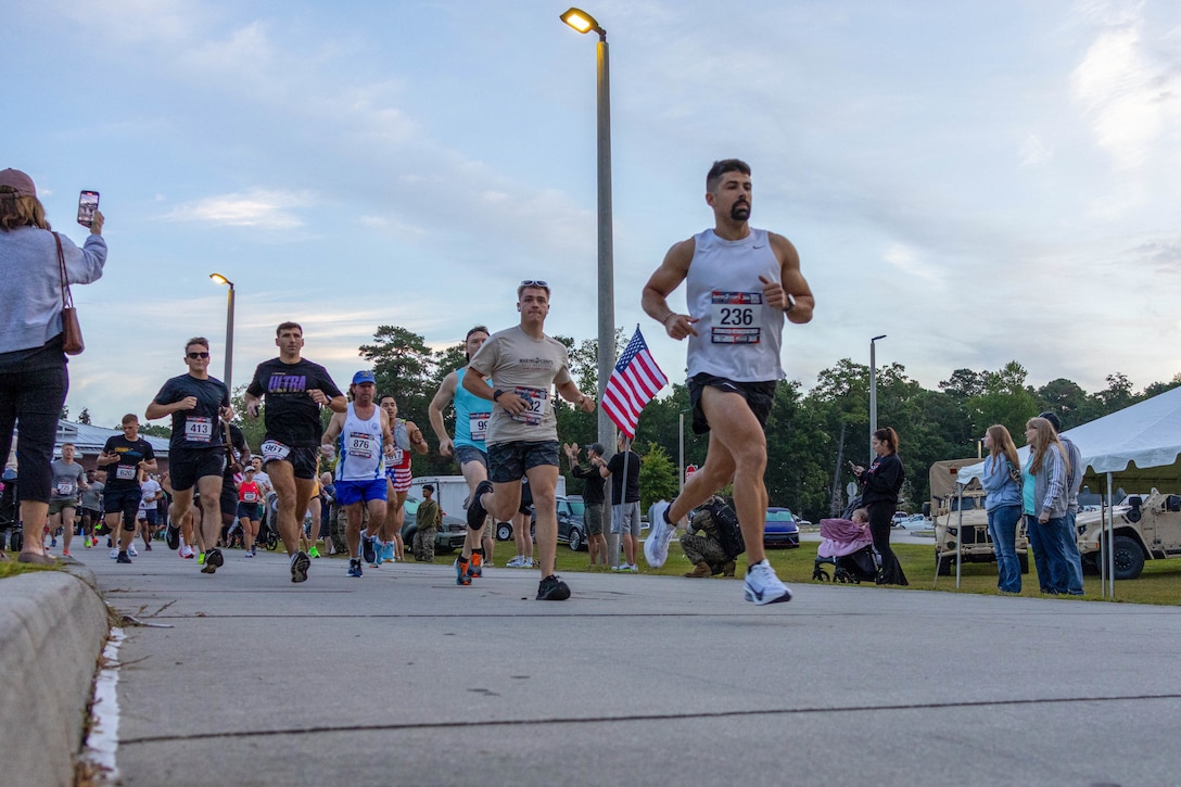 U.S. service members and civilians start the 2025 Marine Corps Half Marathon on Marine Corps Base Camp Lejeune, North Carolina, Sept. 13, 2025. The 13.1-mile race offers a unique opportunity to experience Marine Corps traditions with a dedicated Heroes Mile, honoring those killed in action, before pushing through the final half of the race. (U.S. Marine Corps photo by Cpl. Devaraja Renshaw)