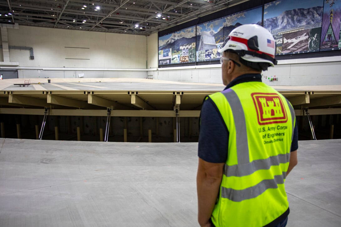 Scott Johnson, quality assurance representative, watches as the state-of-the-art, 200-meter hydraulic banked running track raises as construction continues at the indoor track and field area of the U.S. Air Force Academy’s Cadet Field House, in Colorado Springs, Colorado, Aug. 25, 2025.