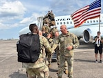 Georgia Army National Guard State Command Sergeant Major John Ballenger and Colonel Christopher Powell, commander of the 648th Maneuver Enhancement Brigade, shake hands with Soldiers of the 863rd Engineer Utilities Detachment as they board a plane for training at Hunter Army Airfield, Ga., before the unit's mobilization in support of United States Africa Command.