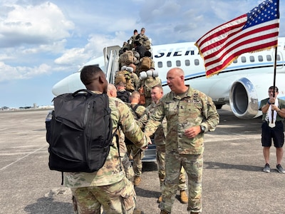 Georgia Army National Guard State Command Sergeant Major John Ballenger and Colonel Christopher Powell, commander of the 648th Maneuver Enhancement Brigade, shake hands with Soldiers of the 863rd Engineer Utilities Detachment as they board a plane for training at Hunter Army Airfield, Ga., before the unit's mobilization in support of United States Africa Command.