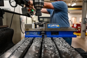 Metal shavings rest on a machine as a engine drive motor adapter is made.