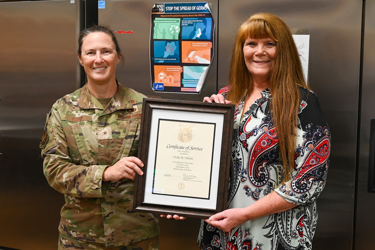 Two women hold a certificate