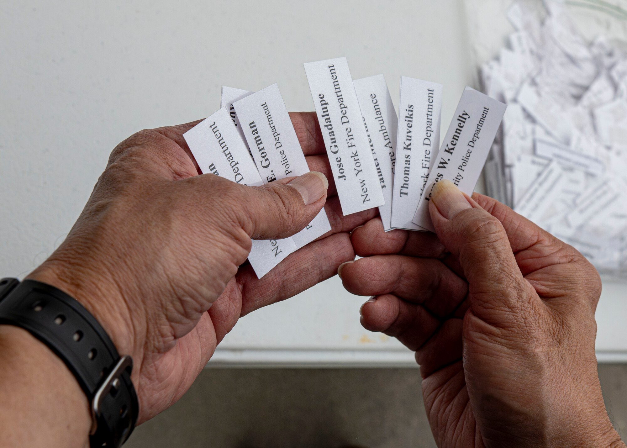 A volunteer prepares names of fallen first responders for participants of the 9/11 Memorial Climb at MacDill Air Force Base, Florida, Sept. 11, 2025. MacDill service members, alongside Hillsborough County firefighters, climbed nine flights of stairs 411 times to honor the 411 first responders who lost their lives during the Sept. 11, 2001, terrorist attacks on the World Trade Center. (U.S. Air Force photo by Airman 1st Class Monique Stober)