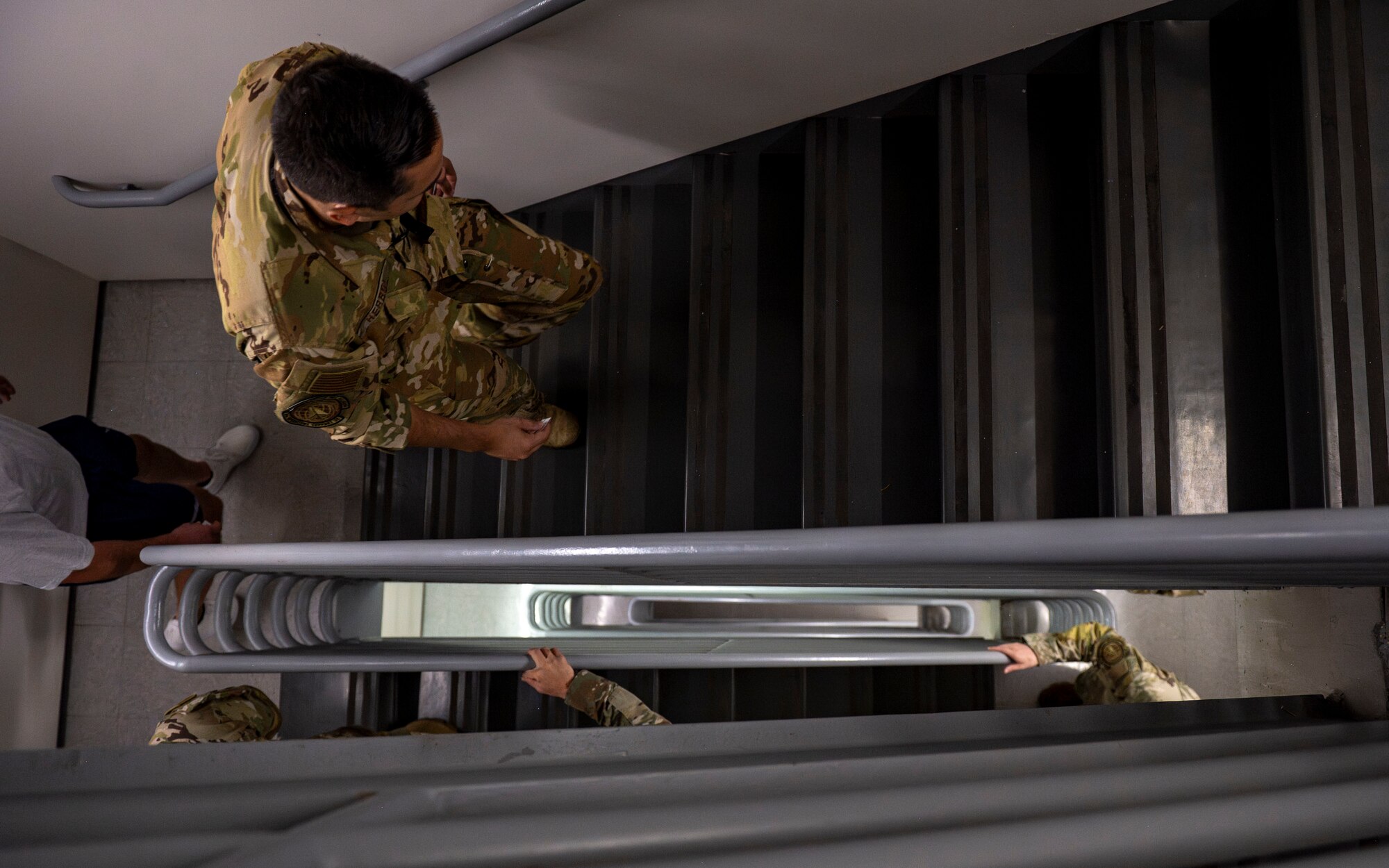 Airmen assigned to the 6th Air Refueling Wing ascend the Air Traffic Control Tower stairs during a 9/11 Memorial Climb at MacDill Air Force Base, Florida, Sept. 11, 2025. Participants climbed nine flights of stairs 411 times to honor the 411 first responders who lost their lives during the Sept. 11, 2001, terrorist attacks on the World Trade Center. (U.S. Air Force photo by Airman 1st Class Monique Stober)