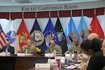 DLA Director Mark Simerly is seated at a conference room table and discussing operational objectives and key results with DLA Energy staff during the annual operating plan meeting.