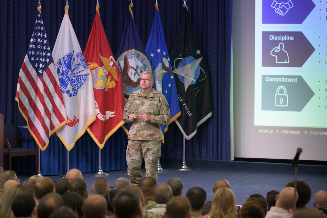 DLA Director Mark Simerly stands in the McNamara Auditorium and engages with DLA Energy personnel at a recent town hall where he outlined strategic priorities for 2026 and setting conditions for future success.