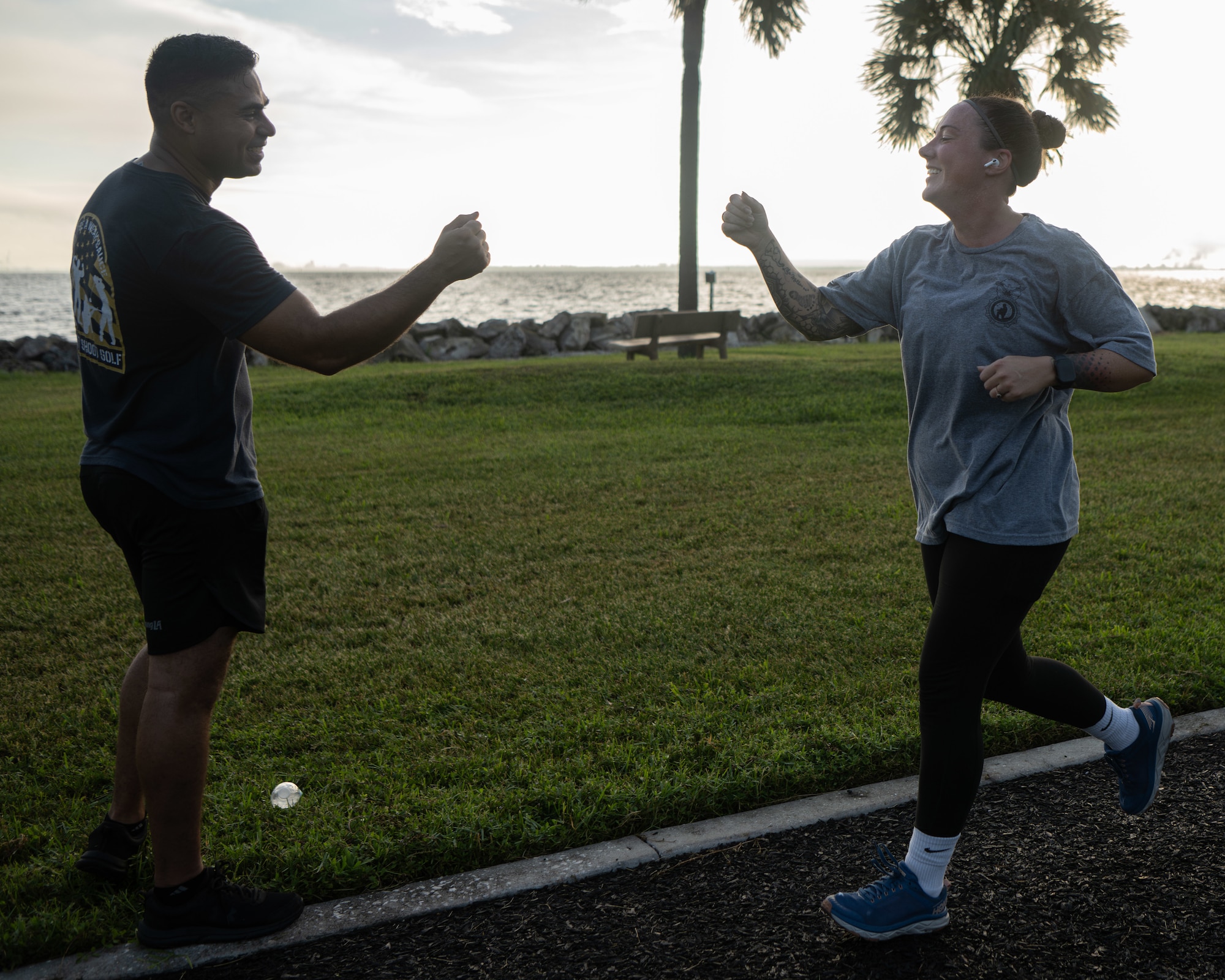 U.S. Air Force Tech. Sgt. Oscar Gomez, 6th Security Forces Squadron standardization and evaluation noncommissioned officer in charge, congratulates Tech. Sgt. Erica Hudson, 6th SFS superintendent, during the 16th annual Helton Hall 5K at MacDill Air Force Base, Florida, Sept. 8, 2025. 1st Lt. Joseph D. Helton Jr., voluntarily deployed from MacDill to Iraq. He extended his tour to continue leading missions, ultimately giving his life during an improvised explosive attack Sept. 8, 2009. (U.S. Air Force photo by Airman 1st Class Helen Ly)