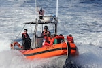 A 26-foot Over-the-Horizon Cutter Boat crew from Coast Guard Cutter Spencer (WMEC 905) transfers aliens from an overcrowded vessel to the Spencer while underway in the Windward Passage, Aug. 29, 2025. All aliens aboard the vessel were repatriated back to Haiti, Sept. 2, following the interdiction. (U.S. Coast Guard photo)