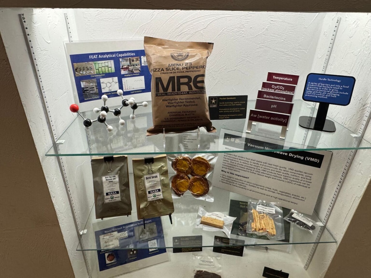 A display shelf includes packaged meals and ration bars.